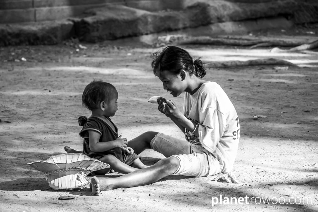 Girl with young child outside Angkor Wat, Siem Reap, Cambodia, 2018