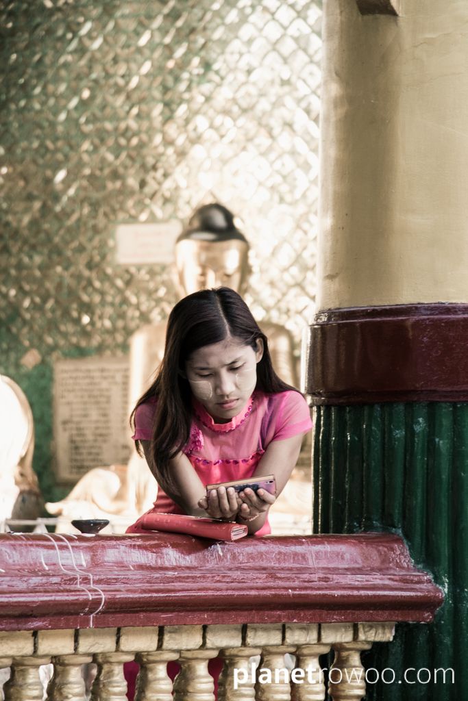 Girl on mobile at the Shwedagon Pagoda, Yangon, Myanmar, 2017