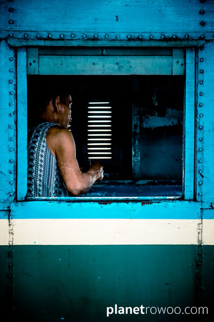 Traveller, through carriage window, Yangon Railway Station, Myanmar, 2017